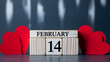 © FatemaAkhter - Valentine's Day wooden calendar block with red hearts and February 14th date