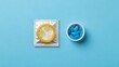 © Candra - Safe choices Condom with blue pills on blue background Prevention concept.