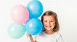 © Anuyj - Indoor portrait of little braided girl holding balloon animals, wearing casual clothes, isolated over gray background, playful celebration