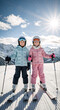 © Milan - Two smiling young girls standing on skis on a sunny winter day. Vertical portrait of sisters in ski gear at a mountain resort