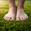 © Tata - Bare feet standing on fresh green moss in natural sunlight