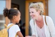 © Natalia - Smiling teacher warmly greets a young girl with curly hair and a backpack at school entrance, creating a welcoming atmosphere for new students