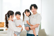 © buritora - Young Asian couple holding a child at home, family, parent and child, family