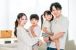 © buritora - Young Asian couple holding a child at home, family, parent and child, family
