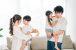 © buritora - Young Asian couple holding a child at home, family, parent and child, family