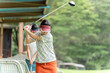 © buritora - Golf player practicing swing at golf driving range, driving range, golf center, female golfer