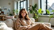 © siriporn - Smiling Woman Relaxing on Sofa in Sunlight-Filled Minimalist Living Room, Cozy Home Portrait