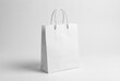 © Yudi - Clean, minimalist blank white paper shopping bag with handles, ideal for product mockups, branding, retail, and eco-friendly packaging designs