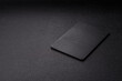 © chernikovatv - A black slate stone board or plate, an empty kitchen utensil. A black slate board