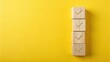 © Vibrant Visions Pixe - Four Wooden Cubes Stacked Vertically Displaying Checkmarks on a Vibrant Yellow Background, Representing Accomplishment and Goal Completion