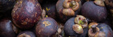 Panorama of fresh raw Mangosteen fruit at a food market
