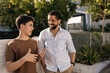 © kleberpicui - Father and teenage son talk casually outdoors in a residential neighborhood, showing trust, emotional connection, active listening, and a healthy family relationship
