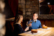 © BGStock72 - Couple shares a toast at a restaurant during dinner in an intimate setting