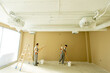 © BGStock72 - Workers painting an interior wall in a commercial space during daylight hours