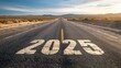 © sablengjago - Long asphalt road with the year 2025 painted prominently, leading towards a sunlit horizon in a vast desert landscape