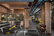 © ardasavasciogullari - Modern Gym Interior with Dumbbells and Machines