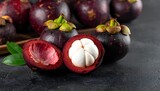 Close-up of fresh mangosteen fruit revealing white flesh against a dark background, highlighting exotic texture and premium tropical freshness for food and health concepts.