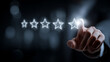 © Martn - A hand selecting a glowing star rating symbol representing evaluation performance quality and customer experience assessment.