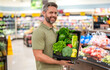 © be free - Fresh food basket. Man in grocery store. Man shopping with vegetable basket in supermarket. Grocery vitamin basket. Hispanic man shopping at grocery store. Healthy lifestyle