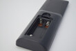 © Maule - Close-up of an open battery compartment in a black plastic device showing metallic spring contacts