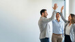 © Anastasiya - Business team celebrates high five win. Smiling team gives high five in modern office, teamwork success concept for newyear kickoff, startup launch, career promotion, copy space, bright tone