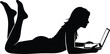 © Parvej Creatives - Silhouette of young woman lying on floor using laptop computer, female freelancer working from home, student studying online, remote business education digital lifestyle.