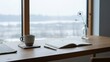 © Photo Moon - Minimalist workspace with coffee mug notebook pen and dandelion flower on wooden desk by window overlooking snowy winter landscape