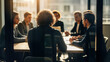 © Muin - Business meeting in a modern office with diverse professionals collaborating around a conference table during a bright, sunlit session, viewed from behind a glass partition