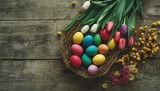 Vivid Easter eggs and tulips arranged on a wooden surface serving as a seasonal decorative display