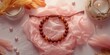 © AIArtistry - Decorative handmade Shamballa jewelry featuring Rudraksha and amber beads arranged on pink tissue with scattered beads and feathers, focusing on artisanal design