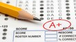 © Helen - Close-up of a yellow pencil marking an A+ grade on a test paper with bubble answers