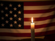 © Sultana - American flag with a lit candle on national day