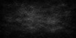 © PAGLAA - A dark grunge black and white texture featuring an old dirty concrete wall pattern with a blank vintage chalkboard surface for an empty grey stone backdrop design