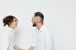 © SHOTPRIME STUDIO - A professional man and colleague share a warm moment against an isolated colored background, communicating confidence, teamwork, and positive emotion in a business setting, while presenting a calm,