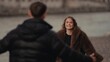© 4kclips - A romantic couple reunites in Paris France with a woman in a fur coat smiling at her partner The image captures love and affection in an urban setting suitable for travel and relationship themes.