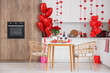 © Pixel-Shot - Interior of kitchen decorated for Valentine's Day with dining table, counters and balloons
