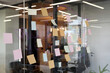 © TrueFrame Collective - Glass wall covered with colorful sticky notes and handwritten diagrams in modern office, brainstorming session in progress
