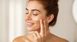 © vadosloginov - Woman Applying Face Cream Healthy Skin