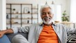 © vadosloginov - Smiling man relaxing on sofa indoors