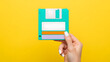© creative - Handmade paper floppy disk in a hand.