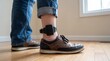 © Pixels Stock - A close up view reveals a person wearing an electronic monitoring device secured around their ankle suggesting house arrest