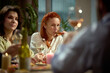 © Lustre Art Group  - Woman drinking wine during friendly dinner. Concept of lifestyle content, wine promotion, casual social moments, restaurant advertising, and food marketing visuals.
