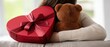 © pvl0707 - Young woman hugs boyfriend at home with heart-shaped gift box for Valentine's Day celebration