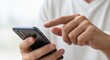 © mashimara - Hands on Technology: A close-up shot of hands interacting with a sleek smartphone, offering a glimpse into modern communication and connectivity.