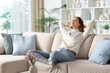 © PheelingsMedia - Relaxed woman in winter resting sitting on a sofa