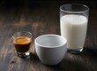 © ramenguy - Espresso shot, glass of milk, and empty white cup on a dark rustic wooden table, ready for coffee preparation.