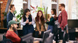 © master1305 - Informal office meeting with diverse team in modern workspace. Concept of inclusive modern office, cross functional collaboration, internal communication, team alignment.