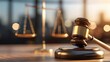 © JT Studio - A close-up of a gavel resting on a desk, with a blurred balance scale in the background, symbolizing justice and the legal system.
