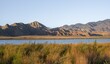 © Mara Brandl/imageBROKER - Blue Toktogul reservoir between dry mountain landscape, hilly mountains in the evening light, Jalalabad region, Kyrgyzstan