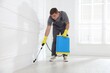 © New Africa - Pest control worker spraying insecticide in room